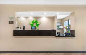 a cashier counter with a green star on the wall at Extended Stay America Suites - Melbourne - Airport in Melbourne +52 photos
