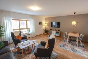a living room with a couch and chairs and a table at Ferienwohnung BGD in Berchtesgaden