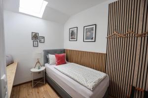a bedroom with a bed with a red pillow on it at Ferienwohnung BGD in Berchtesgaden