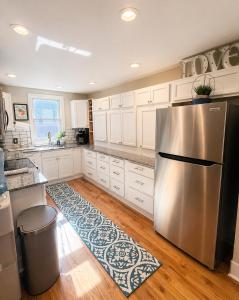 a kitchen with a stainless steel refrigerator and white cabinets at CrazyHart PVD in Providence +32 photos