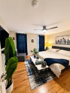 a bedroom with a large bed and a couch at CrazyHart PVD in Providence
