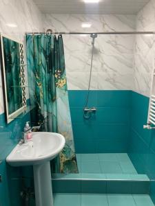 a blue bathroom with a sink and a shower at Armen’s Apartment in Yerevan +67 photos