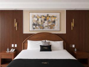ein Schlafzimmer mit einem Bett und einem schwarz-weißen Kissen in der Unterkunft Royal Express Chilpancingo in Chilpancingo de los Bravos