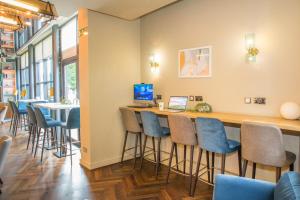 a bar in a restaurant with blue bar stools at Holiday Inn York City Centre by IHG in York