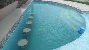 a swimming pool with rocks in the water at Villas Aakal Petirojo in Chicxulub +7 photos
