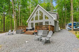 a house with chairs and a table and a boat at Brand New Chalet - Seclusion Arcadez Fire Pit in Locust Lakes Village