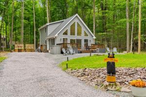 a house in the woods with a sign in front of it at Brand New Chalet - Seclusion Arcadez Fire Pit in Locust Lakes Village