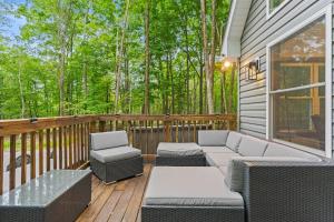 a porch with a couch and chairs on a deck at Brand New Chalet - Seclusion Arcadez Fire Pit in Locust Lakes Village +48 photos