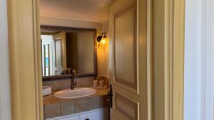 a bathroom with a sink and a mirror at Almira Prassa Beach House Kimolos in Prasonísi +28 photos