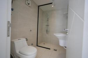 a bathroom with a toilet and a shower and a sink at 12 Durrat Al Arous - Rose Beach Villas in Durat Alarous +21 photos