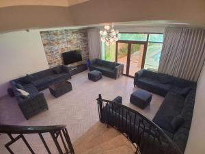 an aerial view of a living room with couches and a television at 12 Durrat Al Arous - Rose Beach Villas in Durat Alarous