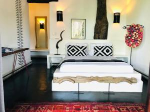 a bedroom with a large white bed in a room at Tribal Hotel in Granada