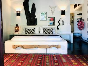 a bedroom with a large bed with a tree on the wall at Tribal Hotel in Granada