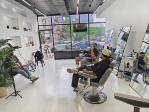 a group of people sitting in chairs in a salon at Grand House in Chicago