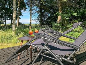 a table and a chair sitting on a deck at 6 person holiday home in Nykøbing M in Hesselbjerg