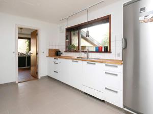 a white kitchen with a sink and a window at 6 person holiday home in Nykøbing M in Hesselbjerg