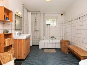 a bathroom with a tub and a sink and a bath tub at 6 person holiday home in Nykøbing M in Hesselbjerg +32 photos