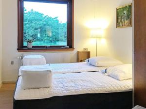 two beds in a room with a window at 6 person holiday home in Nykøbing M in Hesselbjerg