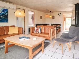 a living room with a couch and a table at 10 person holiday home in Ørsted in Ørsted