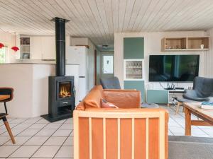 a living room with a couch and a fireplace at 10 person holiday home in Ørsted in Ørsted
