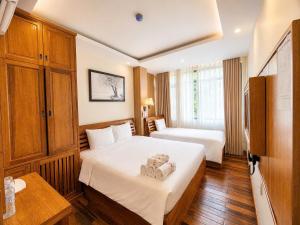 a hotel room with a bed with a teddy bear on it at Senkotel Nha Trang Managed by NEST Group in Nha Trang