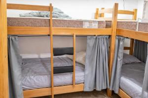 a couple of bunk beds in a room at Rio Vibes Hostel - Hostel na Glória, AC, Social Vibe & Próximo a Lapa in Rio de Janeiro