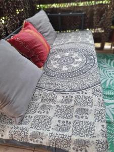 a bed with pillows and a quilt on it at A Kaz Robinson in Sainte-Luce