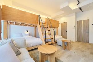 a bedroom with a bunk bed and a couch at Cavatina in Sapporo