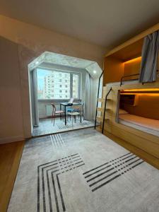 a bedroom with bunk beds and a table and a dining room at GG Hostel MONGOLIA 지지호스텔 몽골 in Ulaanbaatar +18 photos