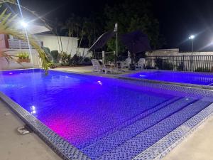 a swimming pool at night with purple lights at La Casa di Giovanna in Alfonso