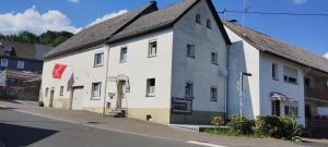 a white building on the side of a street at Ferienhaus check ferien dot world in Berenbach