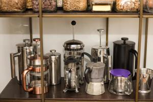 a bunch of silver appliances sitting on a shelf at Nyima Tashi Buddhist Centre in Auckland