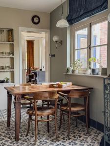 a kitchen with a wooden table and some chairs at Romantische kamer nabij centrum in Eindhoven +32 photos