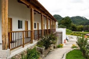 a building with a porch with a fence at Casa Montana Hotel in Chichicastenango