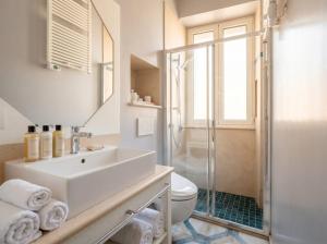 a bathroom with a sink and a toilet and a shower at Dimora BoxFish - Panorama terrace in Polignano a Mare +13 photos