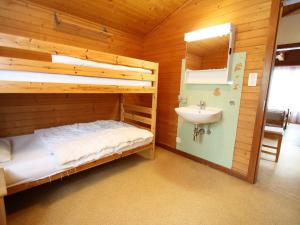 a bathroom with a bunk bed and a sink at Spacious chalet in Randogne near Crans Montana in Randogne