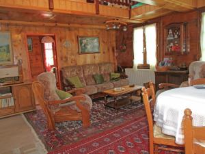 a living room with a couch and a table at Boutique Apartment in Valais with Balcony in Guttet-Feschel