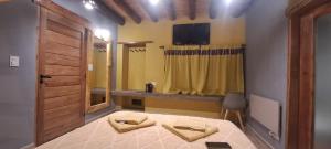 a bedroom with a bed and a tv on the wall at Ocres de mi Tierra in Tilcara