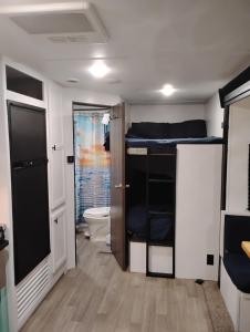 a small room with a bed and a toilet at Camper Rental in Saint Helena Island