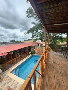a view of the pool from the balcony of a house at Cabañas Sol y Mar in San Antero
