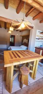 a wooden picnic table in a room with a bed at Ocres de mi Tierra in Tilcara