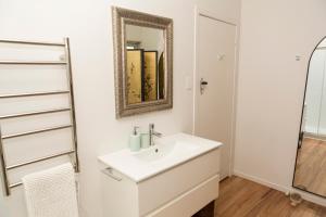 a bathroom with a sink and a mirror at Nyima Tashi Buddhist Centre in Auckland +38 photos
