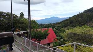 a view of a red roofed house in the mountains at Cabaña vista Volcán Barú in Gualaca