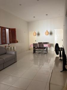 a living room with a couch and a table at Casa TS Morro Branco in Beberibe