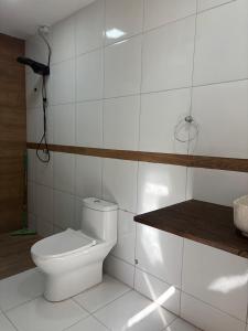 a white bathroom with a toilet and a counter at Casa TS Morro Branco in Beberibe +19 photos