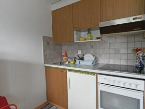 a kitchen with a sink and a stove top oven at Modern Apartment in Mastrils with Terrace near Forest in Mastrils