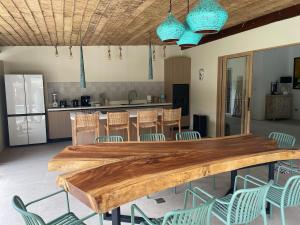 a kitchen with a large wooden table and chairs at Ubuntu Villa in Ko Phangan