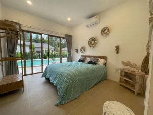 a bedroom with a bed and a pool at Ubuntu Villa in Ko Phangan +27 photos