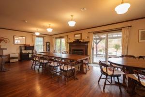 a dining room with a large table and chairs at Lodge Kent & Cottage Kent in Hokuto