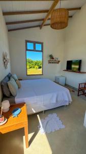 a bedroom with a large bed and a window at Casa Mangaba da Praia in Prado +39 photos